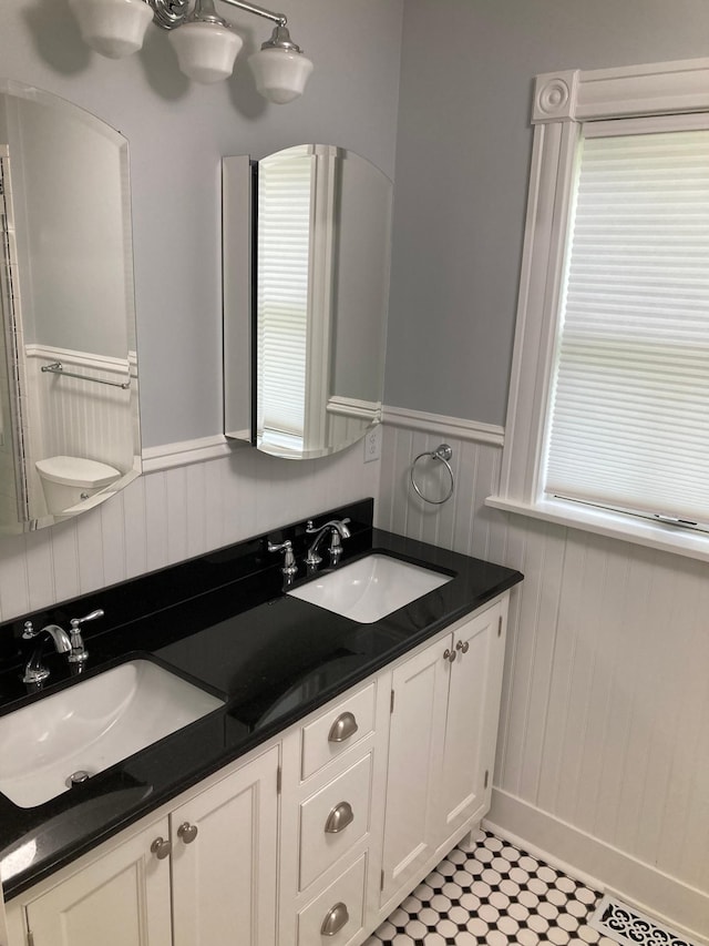 112 Harriet St S, Stillwater, MN 55082 - bathroom featuring wainscoting, double vanity, and plenty of natural light