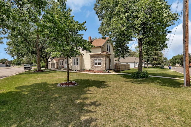 607 23rd Ave N, Saint Cloud, MN 56303 - view of property hidden behind natural elements featuring stone siding, stucco siding, a front yard, and a chimney