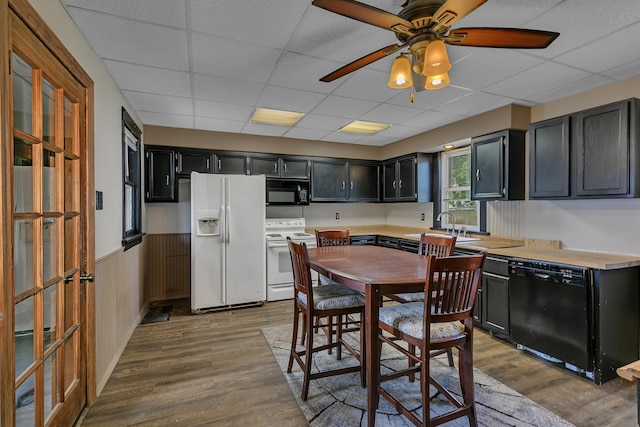 607 23rd Ave N, Saint Cloud, MN 56303 - kitchen with black appliances, dark cabinetry, a paneled ceiling, wood finished floors, and light countertops