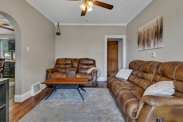 607 23rd Ave N, Saint Cloud, MN 56303 - living room with ceiling fan, wood finished floors, crown molding, arched walkways, and baseboards