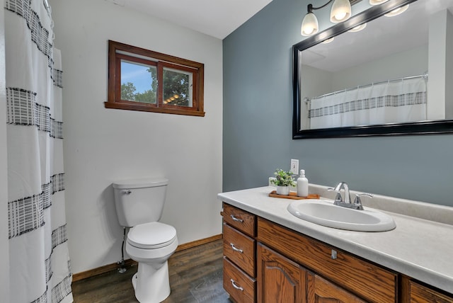 607 23rd Ave N, Saint Cloud, MN 56303 - full bathroom featuring wood finished floors, vanity, toilet, baseboards, and a shower with curtain