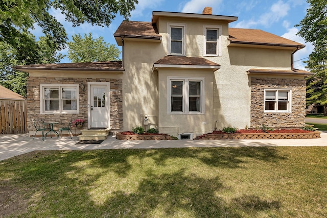 607 23rd Ave N, Saint Cloud, MN 56303 - view of front of house featuring stucco siding, a chimney, stone siding, and a patio area