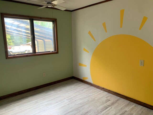 320 Wagonner Ave E, Hackensack, MN 56452 - spare room with light wood-type flooring, a ceiling fan, baseboards, and crown molding