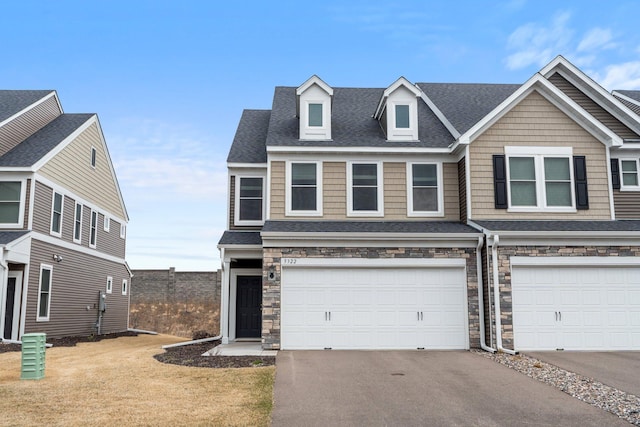5322 94th Ln N, Brooklyn Park, MN 55443 - view of front of home with driveway, stone siding, an attached garage, and a shingled roof