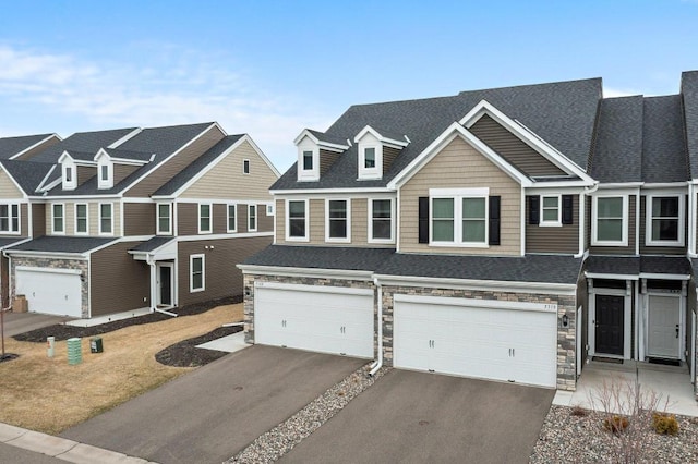 5322 94th Ln N, Brooklyn Park, MN 55443 - view of property featuring driveway, stone siding, an attached garage, and a shingled roof