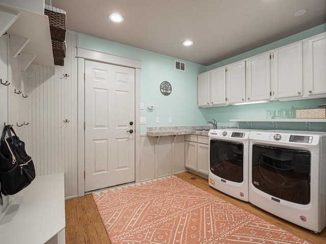 15564 Vale St NW, Andover, MN 55304 - laundry area featuring washer and dryer, light wood-style floors, recessed lighting, and cabinet space