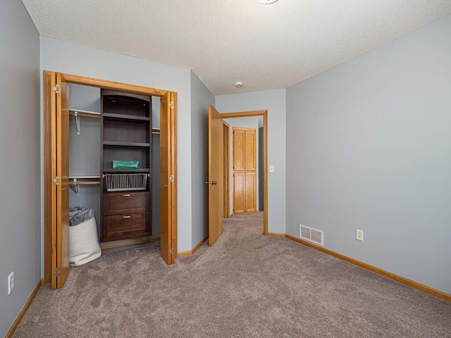 15564 Vale St NW, Andover, MN 55304 - unfurnished bedroom featuring a closet, carpet floors, baseboards, and a textured ceiling
