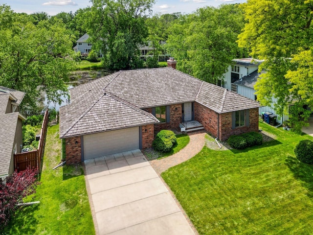 5620 Woodcrest Dr, Edina, MN 55424 - view of front of house featuring brick siding, a front yard, driveway, and a chimney