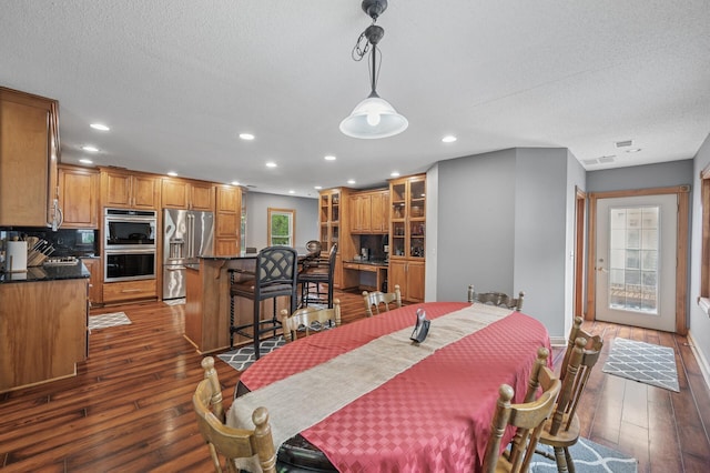 631 Bench St, Taylors Falls, MN 55084 - dining room featuring dark wood-style floors, recessed lighting, a textured ceiling, and baseboards