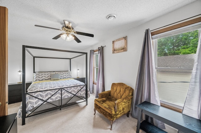 631 Bench St, Taylors Falls, MN 55084 - bedroom with light colored carpet, a textured ceiling, and ceiling fan