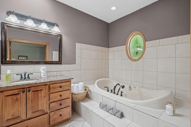 631 Bench St, Taylors Falls, MN 55084 - full bathroom featuring vanity, tile walls, a garden tub, and tile patterned flooring