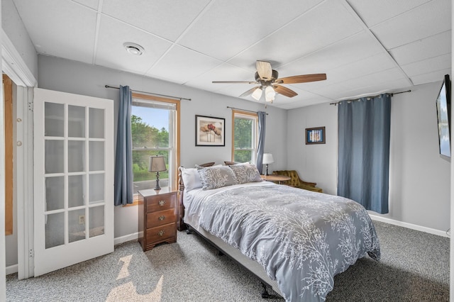 631 Bench St, Taylors Falls, MN 55084 - carpeted bedroom with a drop ceiling, baseboards, and ceiling fan