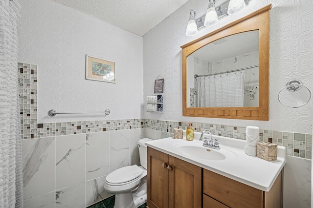 631 Bench St, Taylors Falls, MN 55084 - full bathroom featuring tile walls, vanity, toilet, a textured ceiling, and wainscoting