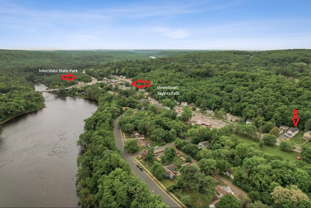 631 Bench St, Taylors Falls, MN 55084 - drone / aerial view of a heavily wooded area and a large body of water