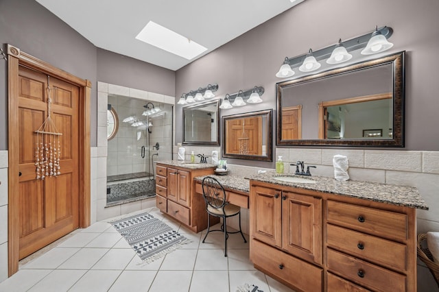 631 Bench St, Taylors Falls, MN 55084 - bathroom with a skylight, double vanity, a stall shower, and tile patterned floors