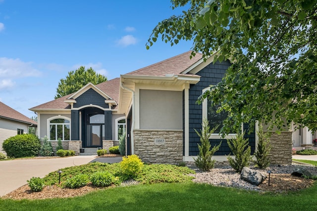 11883 Flanders Cir NE, Blaine, MN 55449 - craftsman house with stone siding and a shingled roof
