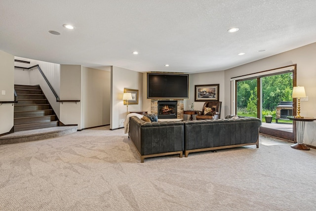 11883 Flanders Cir NE, Blaine, MN 55449 - living area featuring a lit fireplace, light carpet, recessed lighting, stairway, and a textured ceiling