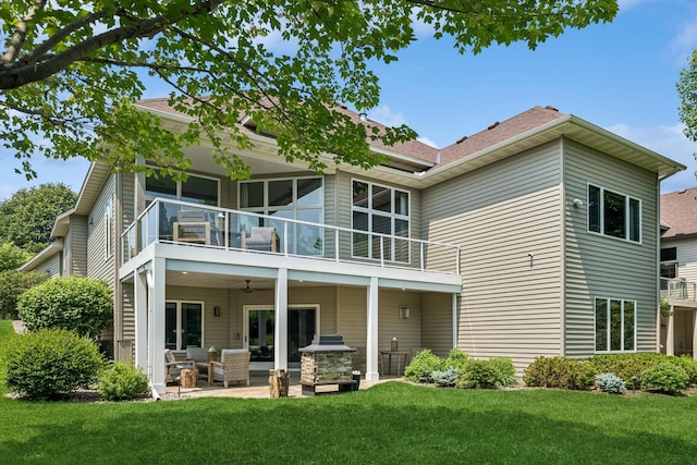 11883 Flanders Cir NE, Blaine, MN 55449 - rear view of house featuring a balcony, an outdoor hangout area, a lawn, a patio area, and a ceiling fan