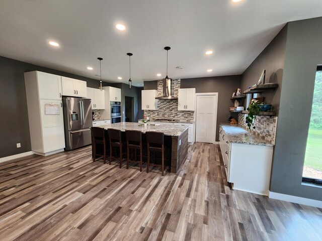 26575 US-71, Arago Twp, MN 56470 - kitchen with stainless steel appliances, open shelves, wall chimney exhaust hood, backsplash, and white cabinetry