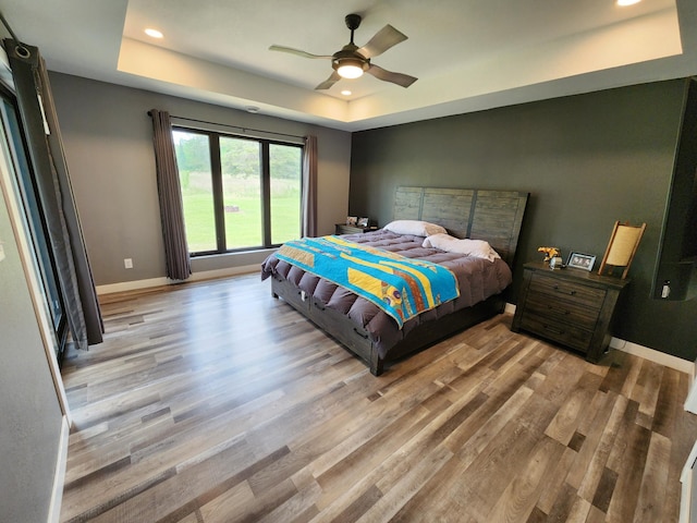 26575 US-71, Arago Twp, MN 56470 - bedroom featuring a raised ceiling, wood finished floors, recessed lighting, baseboards, and ceiling fan