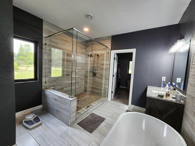 26575 US-71, Arago Twp, MN 56470 - full bath with a freestanding tub, a shower stall, vanity, baseboards, and recessed lighting