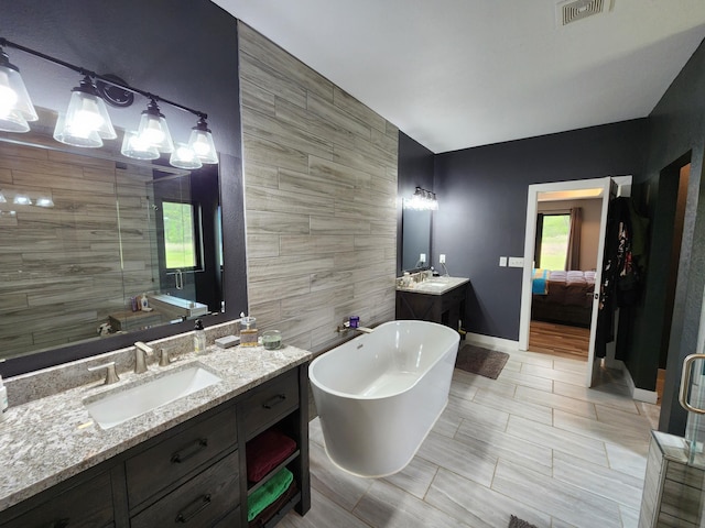 26575 US-71, Arago Twp, MN 56470 - full bath with a soaking tub, two vanities, ensuite bathroom, a shower stall, and baseboards