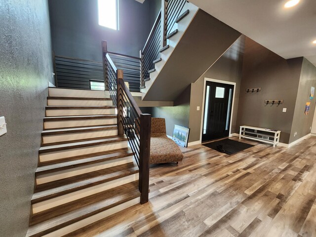26575 US-71, Arago Twp, MN 56470 - foyer featuring stairs, wood finished floors, baseboards, a high ceiling, and recessed lighting