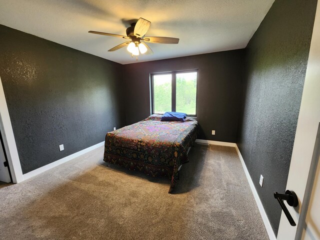 26575 US-71, Arago Twp, MN 56470 - bedroom with a textured wall, carpet floors, baseboards, and ceiling fan