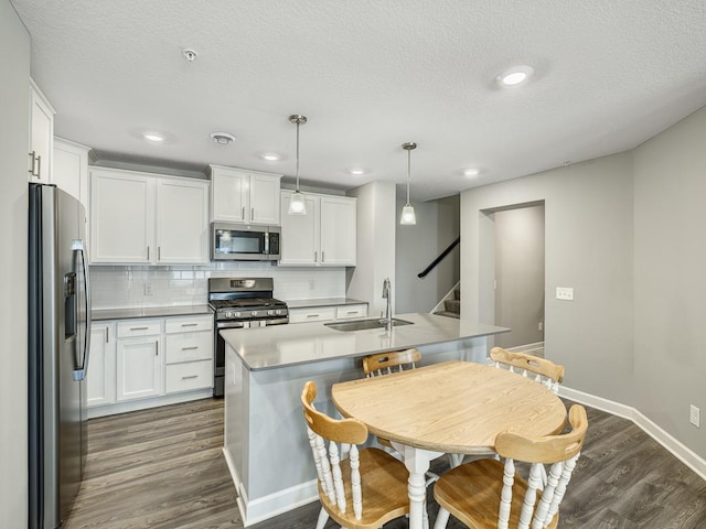 1211 Lower 143rd St E, Rosemount, MN 55068 - kitchen featuring appliances with stainless steel finishes, a sink, dark wood-style floors, decorative backsplash, and white cabinets