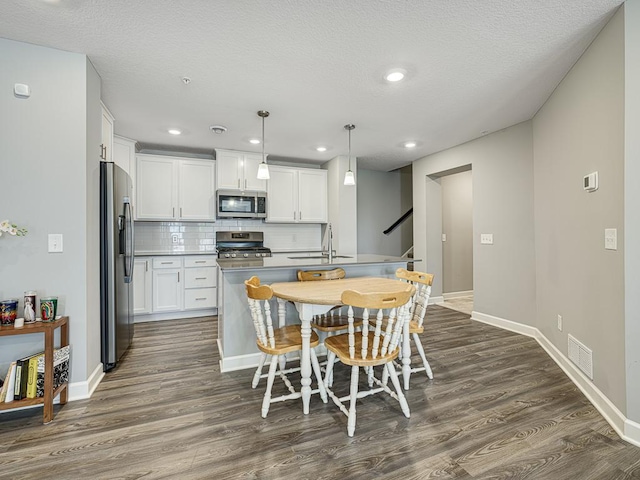 1211 Lower 143rd St E, Rosemount, MN 55068 - dining space featuring dark wood-type flooring, baseboards, recessed lighting, and a textured ceiling