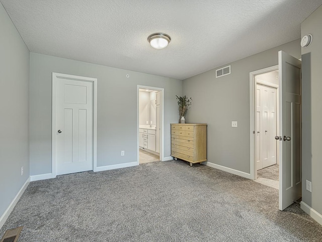 1211 Lower 143rd St E, Rosemount, MN 55068 - unfurnished bedroom with light colored carpet, baseboards, a textured ceiling, and ensuite bathroom