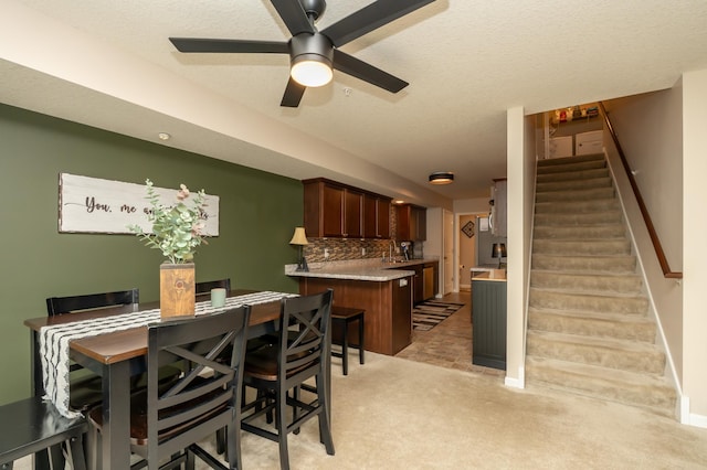201 Chandler Ct, Jordan, MN 55352 - dining room with stairs, light colored carpet, a ceiling fan, baseboards, and a textured ceiling