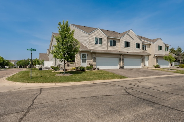 201 Chandler Ct, Jordan, MN 55352 - view of front facade with an attached garage, driveway, a front yard, and stone siding