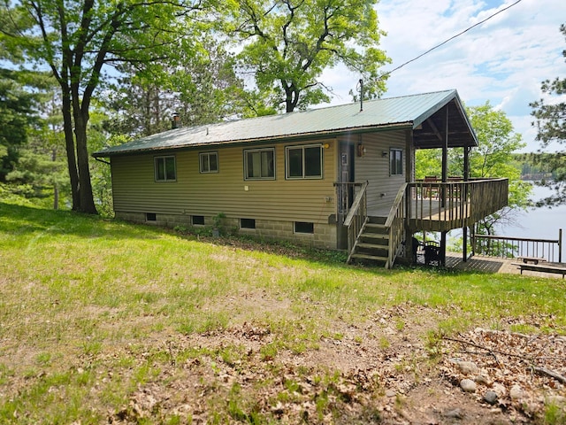 24429 Camp Lake Rd, Garrison, MN 56401 - rear view of house with a wooden deck and metal roof
