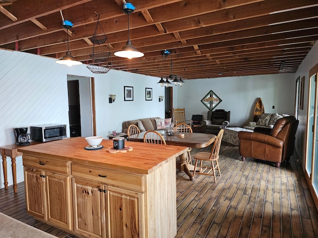24429 Camp Lake Rd, Garrison, MN 56401 - kitchen featuring butcher block counters, open floor plan, dark wood finished floors, and stainless steel microwave