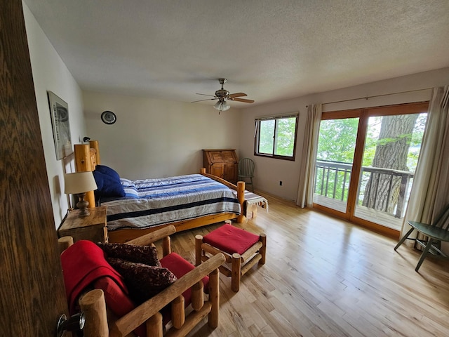 24429 Camp Lake Rd, Garrison, MN 56401 - bedroom featuring access to exterior, wood finished floors, a textured ceiling, and a ceiling fan