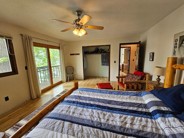 24429 Camp Lake Rd, Garrison, MN 56401 - bedroom featuring wood finished floors, access to exterior, and a ceiling fan