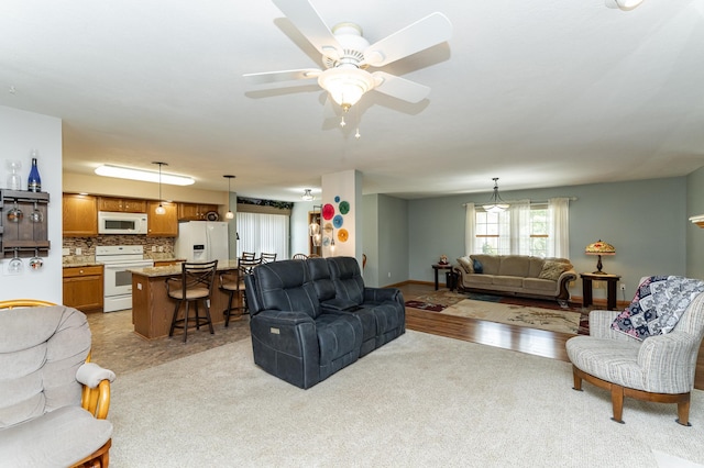 1218 6th St NW, Dodge Center, MN 55927 - living area with a ceiling fan and light carpet