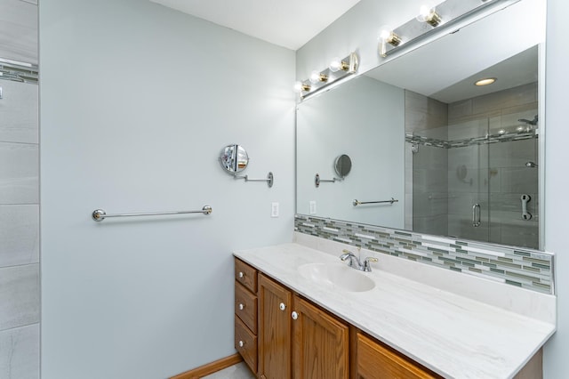 1218 6th St NW, Dodge Center, MN 55927 - bathroom with tasteful backsplash, vanity, a shower stall, and baseboards