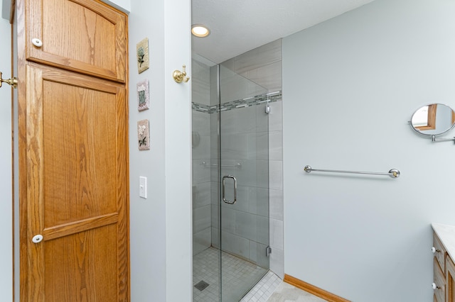 1218 6th St NW, Dodge Center, MN 55927 - bathroom with a shower stall, vanity, baseboards, and tile patterned floors