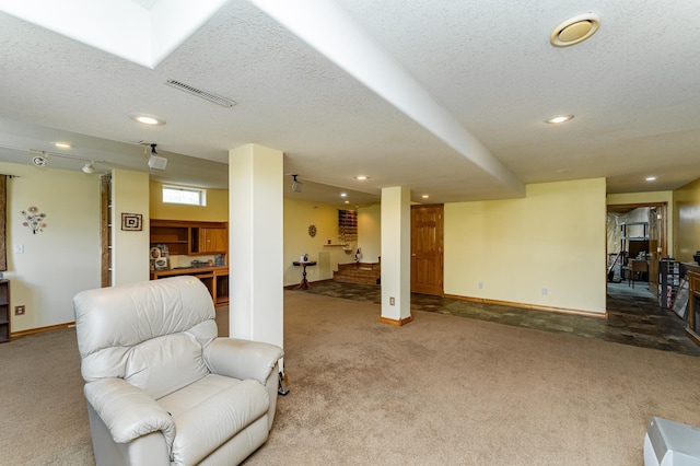 1218 6th St NW, Dodge Center, MN 55927 - carpeted living area featuring recessed lighting, baseboards, and a textured ceiling