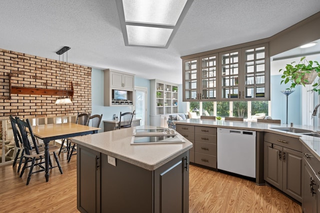 1902 Duck Pond Dr W, Saint Paul, MN 55118 - kitchen featuring white dishwasher, gray cabinets, a kitchen island, a textured ceiling, and light wood-type flooring