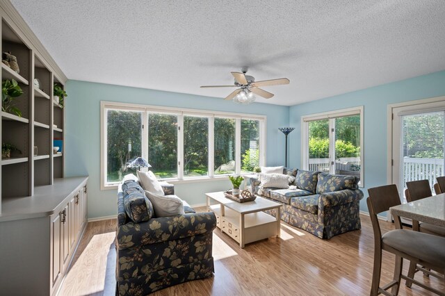 1902 Duck Pond Dr W, Saint Paul, MN 55118 - living area with a ceiling fan, a textured ceiling, healthy amount of natural light, and light wood-style floors