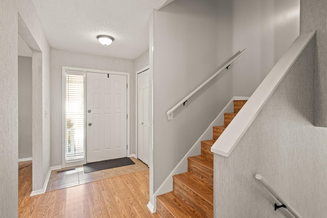 1902 Duck Pond Dr W, Saint Paul, MN 55118 - entryway featuring plenty of natural light, wood finished floors, and a textured ceiling