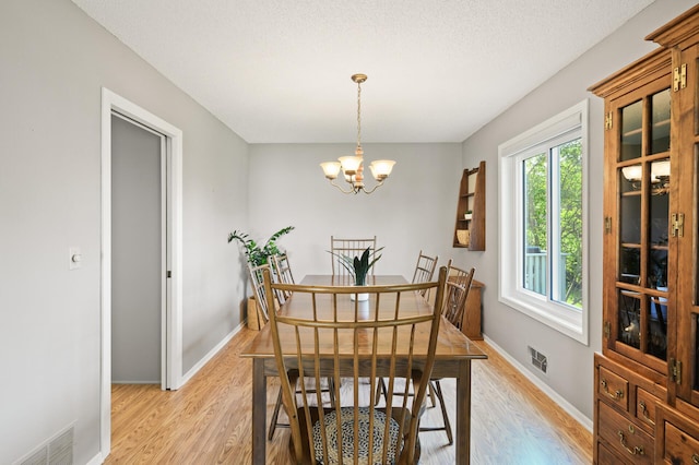 1902 Duck Pond Dr W, Saint Paul, MN 55118 - dining space featuring light wood finished floors and a chandelier