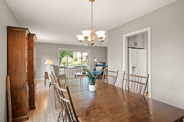 1902 Duck Pond Dr W, Saint Paul, MN 55118 - dining space with light wood-type flooring and a chandelier
