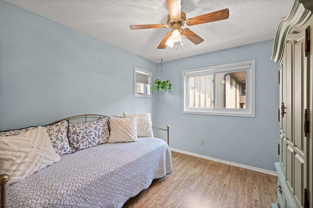 1902 Duck Pond Dr W, Saint Paul, MN 55118 - bedroom with a textured ceiling, light wood-style flooring, and ceiling fan