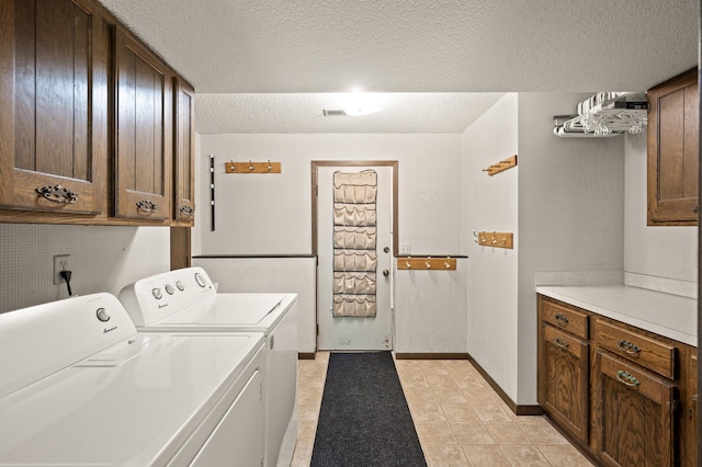 1902 Duck Pond Dr W, Saint Paul, MN 55118 - laundry room with washer and clothes dryer, cabinet space, and a textured ceiling