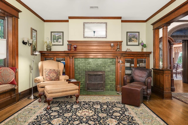 880 Fairmount Ave, Saint Paul, MN 55105 - living area with a tiled fireplace, wood finished floors, crown molding, and ornate columns