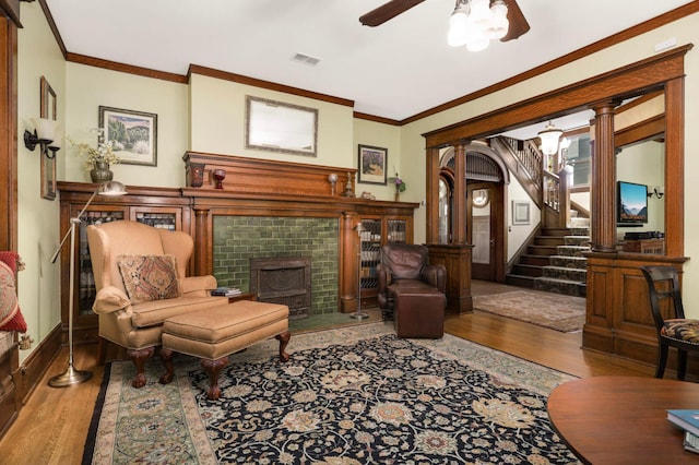880 Fairmount Ave, Saint Paul, MN 55105 - living area with wood finished floors, ornamental molding, ceiling fan, a tile fireplace, and stairs